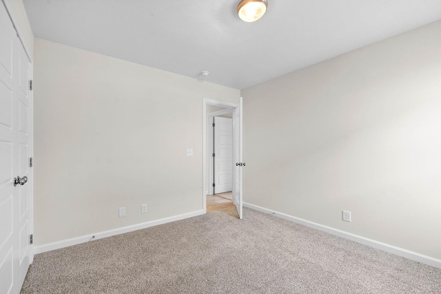 unfurnished bedroom with light carpet and baseboards