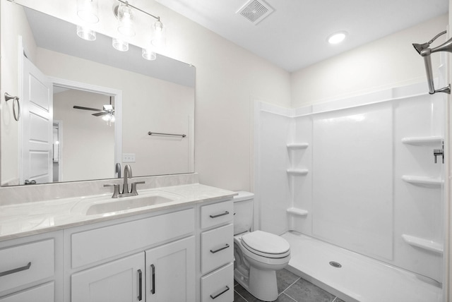 bathroom featuring a shower, visible vents, toilet, vanity, and tile patterned floors