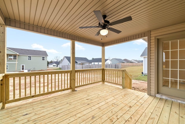 wooden deck with fence, a residential view, and a ceiling fan