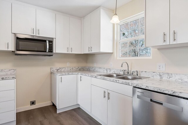 kitchen with a sink, light countertops, white cabinets, and stainless steel appliances