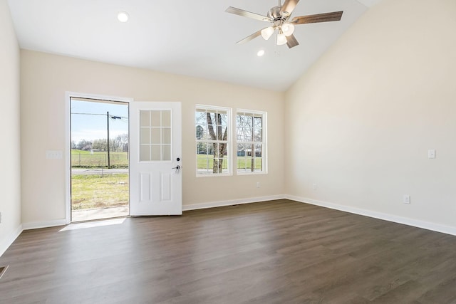 spare room with dark wood-type flooring, a healthy amount of sunlight, baseboards, and ceiling fan