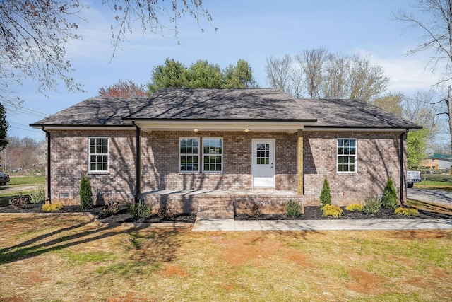 back of house with crawl space, a yard, and brick siding