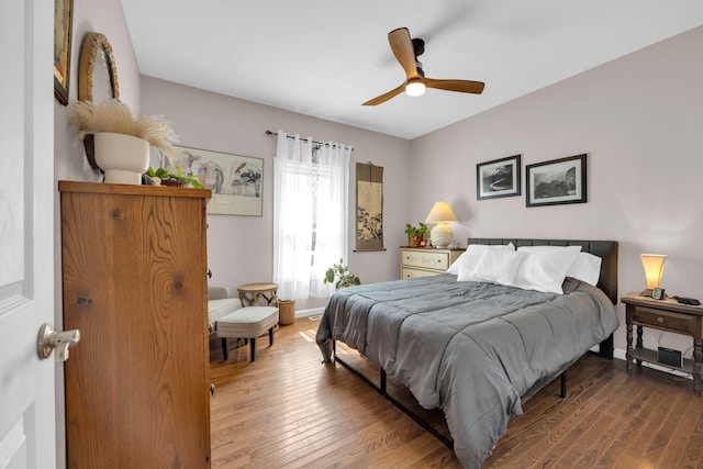 bedroom with hardwood / wood-style flooring, baseboards, and a ceiling fan