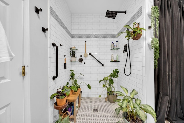 bathroom with a tile shower