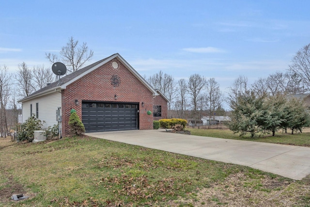 view of home's exterior featuring a garage, a yard, brick siding, and driveway