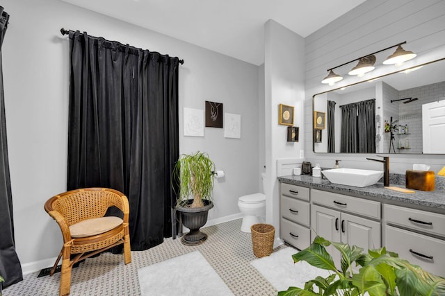 bathroom featuring baseboards, toilet, a shower with curtain, tile patterned floors, and vanity