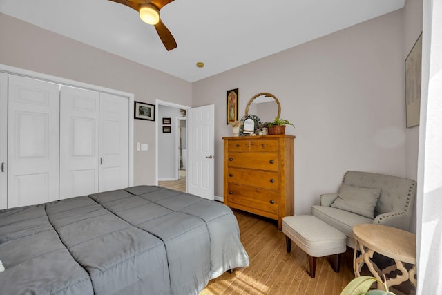 bedroom with light wood finished floors, a ceiling fan, and a closet