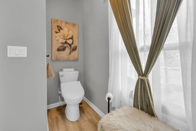 bathroom featuring tile patterned floors, toilet, and baseboards