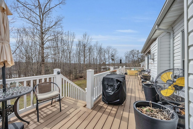 wooden terrace with a grill