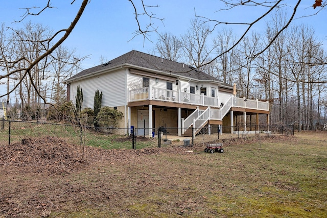 rear view of property with a deck, stairway, and fence private yard