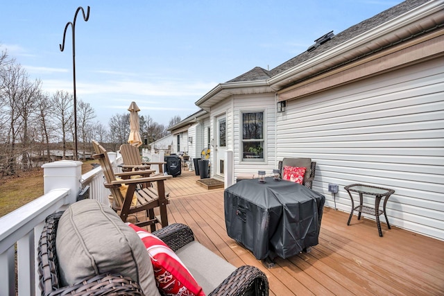 wooden deck featuring a grill