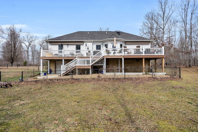 rear view of property with fence private yard, stairway, a lawn, and a wooden deck