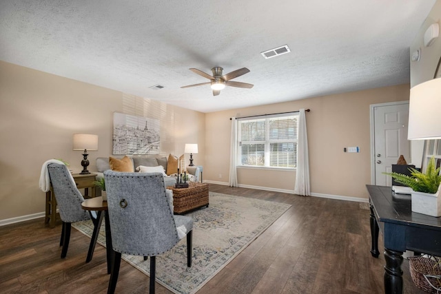 bedroom featuring baseboards, visible vents, and dark wood finished floors