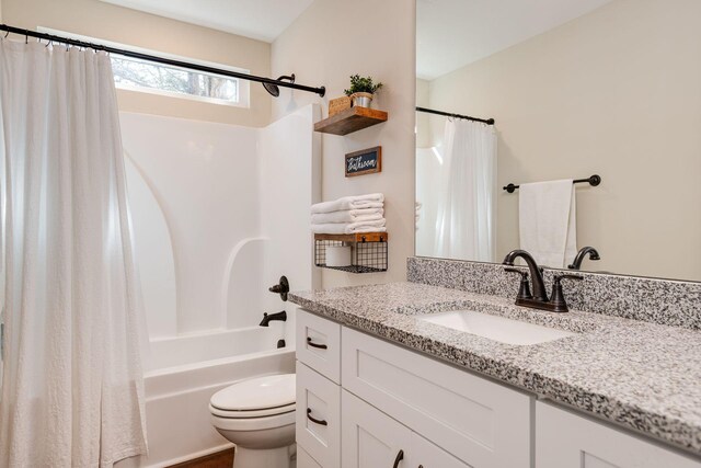 full bathroom featuring shower / bathtub combination with curtain, toilet, and vanity