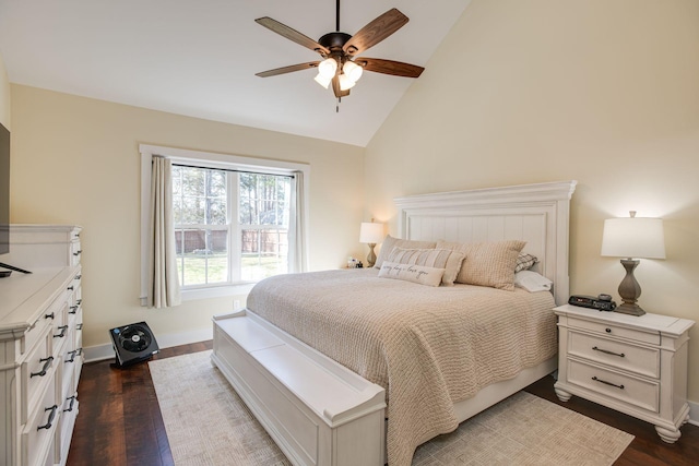 bedroom featuring dark wood finished floors, baseboards, lofted ceiling, and a ceiling fan