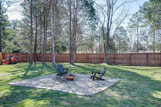 view of yard featuring a fenced backyard and an outdoor fire pit