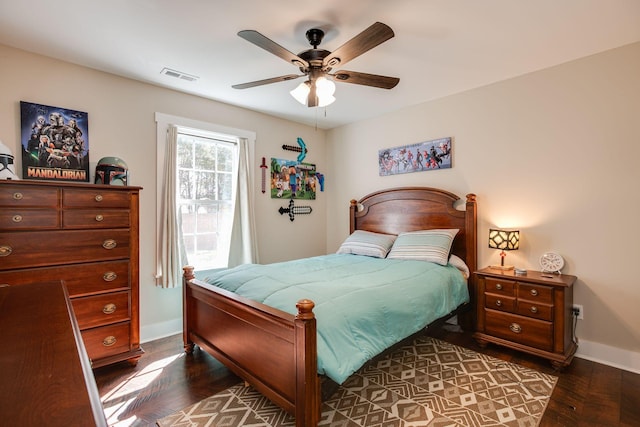 bedroom with visible vents, a ceiling fan, dark wood-type flooring, and baseboards