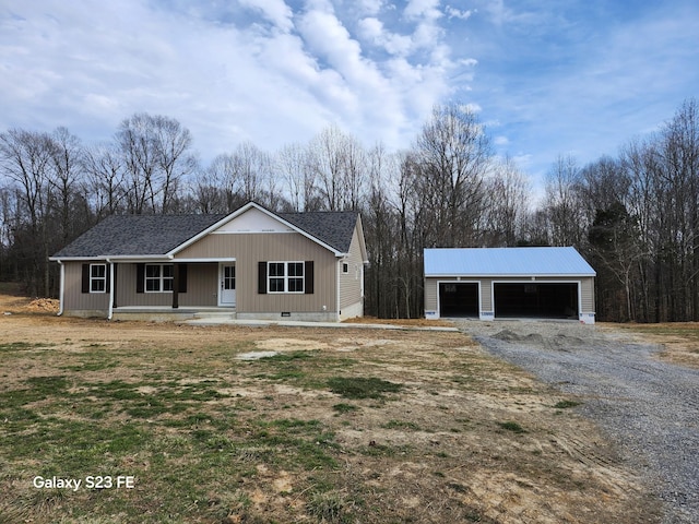 view of front of house with an outbuilding, a porch, a detached garage, roof with shingles, and crawl space