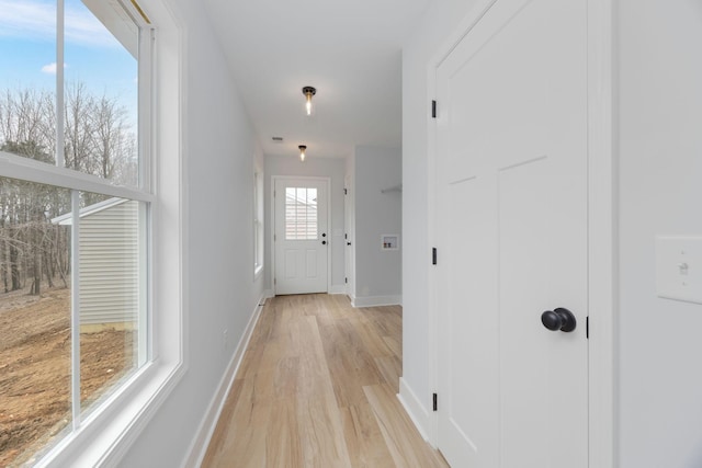 entryway with light wood-type flooring and baseboards