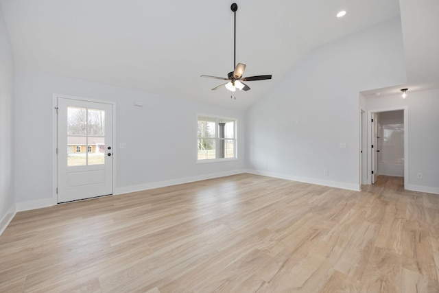 unfurnished living room with light wood-style floors, plenty of natural light, and baseboards