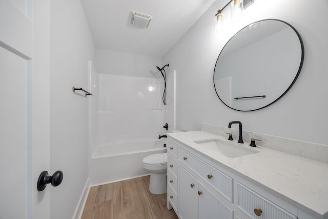 full bath with toilet, wood finished floors, vanity, visible vents, and shower / bathing tub combination