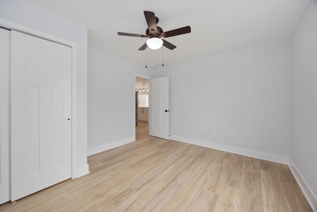 unfurnished bedroom featuring ceiling fan, wood finished floors, and baseboards