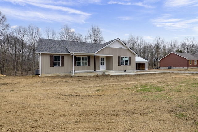 view of front of home featuring covered porch, a shingled roof, crawl space, and a detached garage