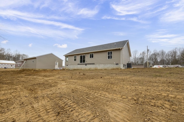 rear view of house featuring crawl space and central AC unit