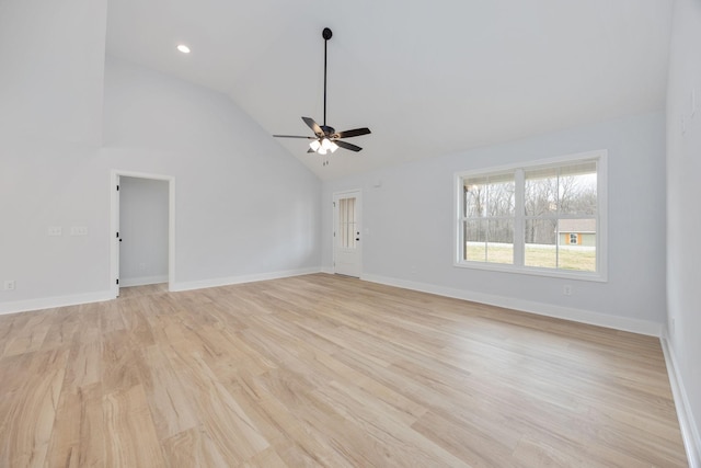 spare room with baseboards, ceiling fan, light wood-style floors, high vaulted ceiling, and recessed lighting