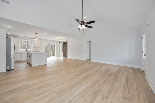 unfurnished living room featuring visible vents, light wood-style flooring, and baseboards