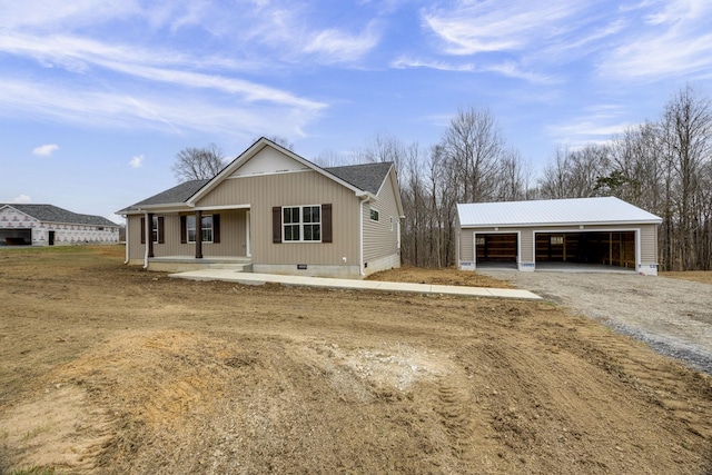 view of front of house featuring an outbuilding, roof with shingles, a detached garage, a porch, and crawl space