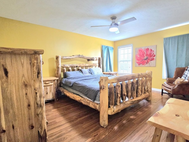 bedroom with dark wood-style floors, baseboards, and a ceiling fan