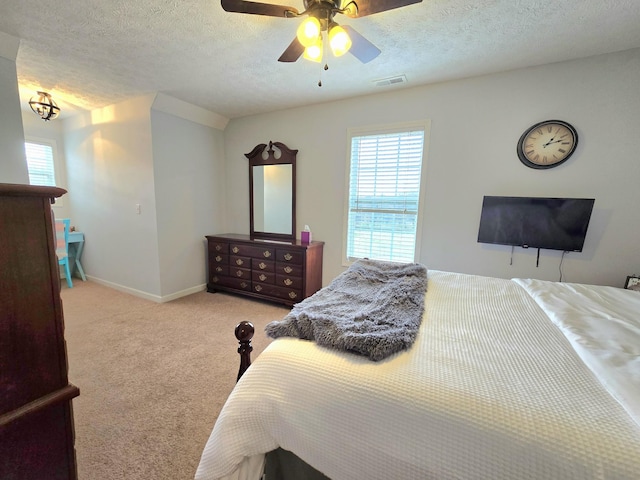 bedroom with carpet floors, multiple windows, visible vents, and a ceiling fan