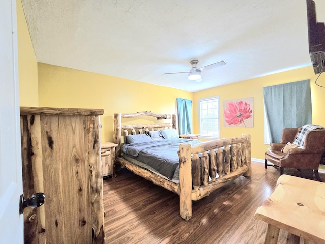 bedroom with a ceiling fan, dark wood finished floors, and baseboards