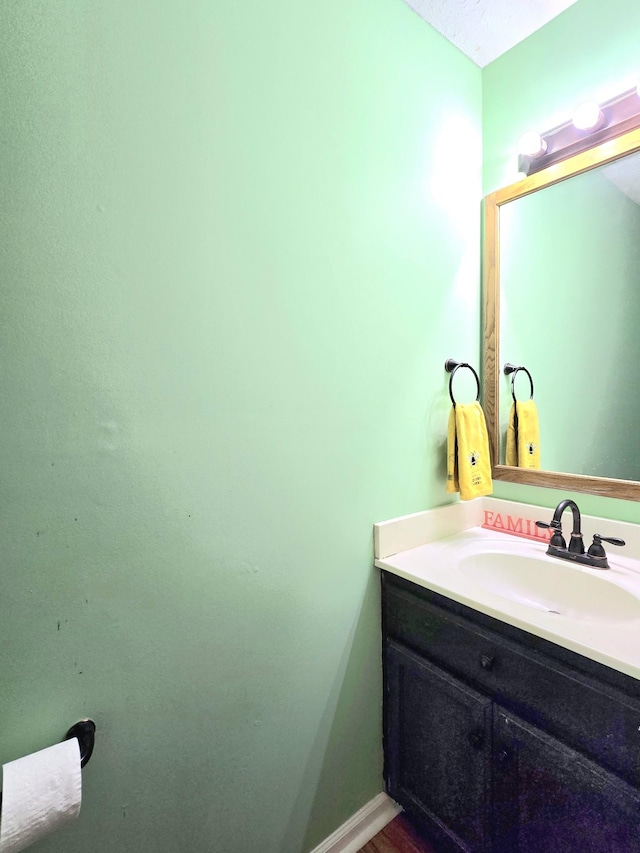 bathroom with vanity and baseboards