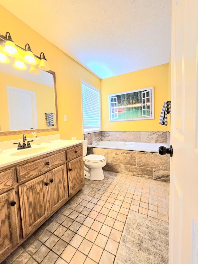 full bath with tiled bath, vanity, toilet, and tile patterned floors