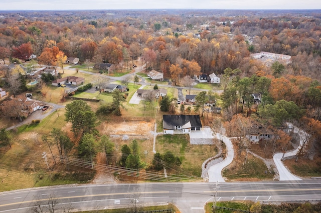 drone / aerial view with a residential view and a wooded view