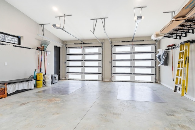 garage with baseboards and a garage door opener