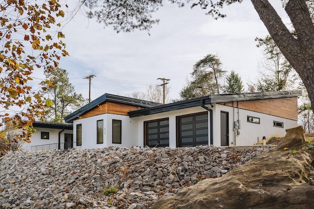 modern home with a garage and stucco siding