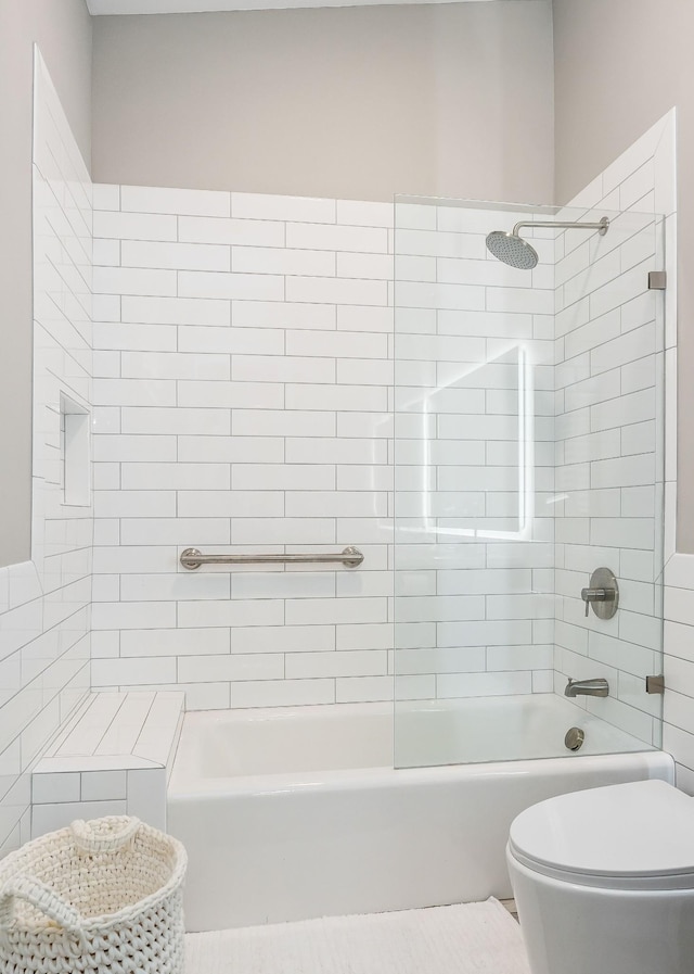 bathroom with shower / washtub combination and toilet