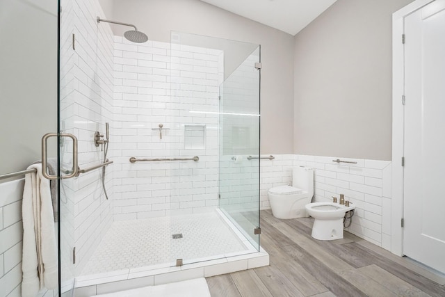 bathroom featuring tile walls, a shower stall, and toilet