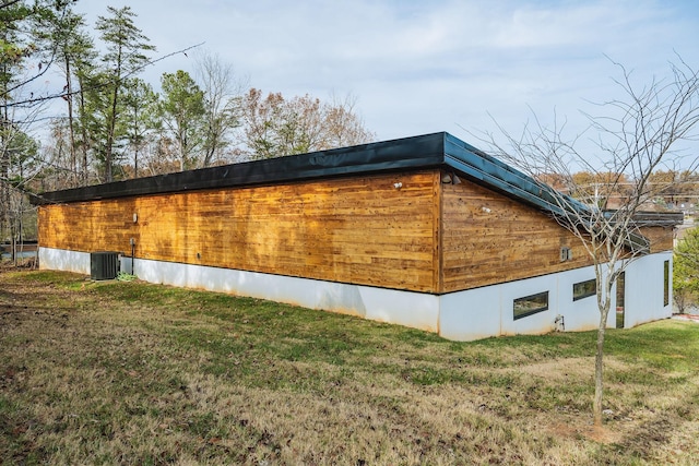 view of property exterior featuring a yard and central AC unit