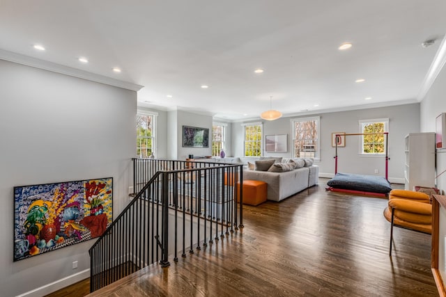 living room with recessed lighting, crown molding, baseboards, and wood finished floors