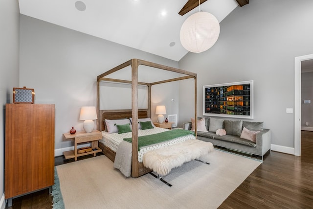 bedroom with high vaulted ceiling, baseboards, and wood finished floors