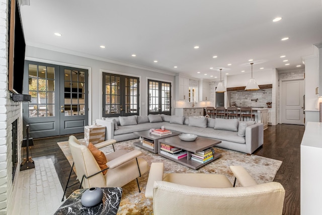 living area with ornamental molding, recessed lighting, french doors, and dark wood-type flooring