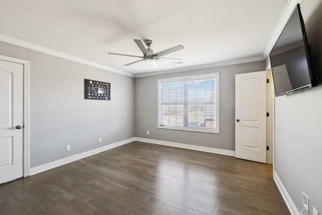 empty room with baseboards, visible vents, ceiling fan, dark wood-type flooring, and crown molding