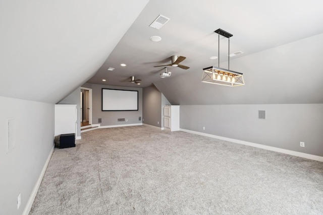 interior space featuring lofted ceiling, baseboards, visible vents, and ceiling fan