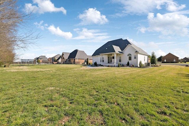 exterior space featuring cooling unit, a yard, and fence