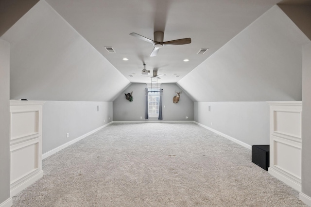 bonus room featuring lofted ceiling, ceiling fan, carpet floors, visible vents, and baseboards