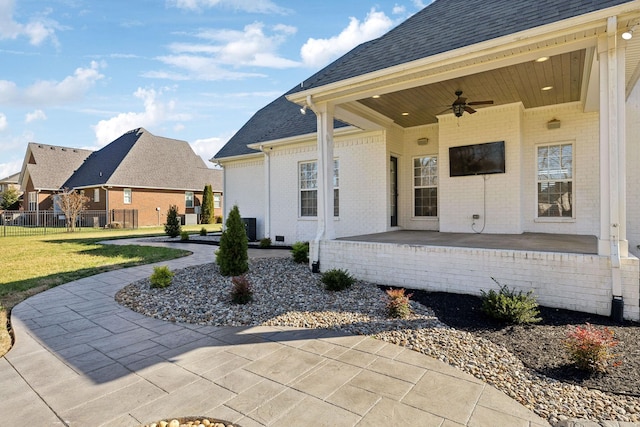 view of patio with ceiling fan and fence